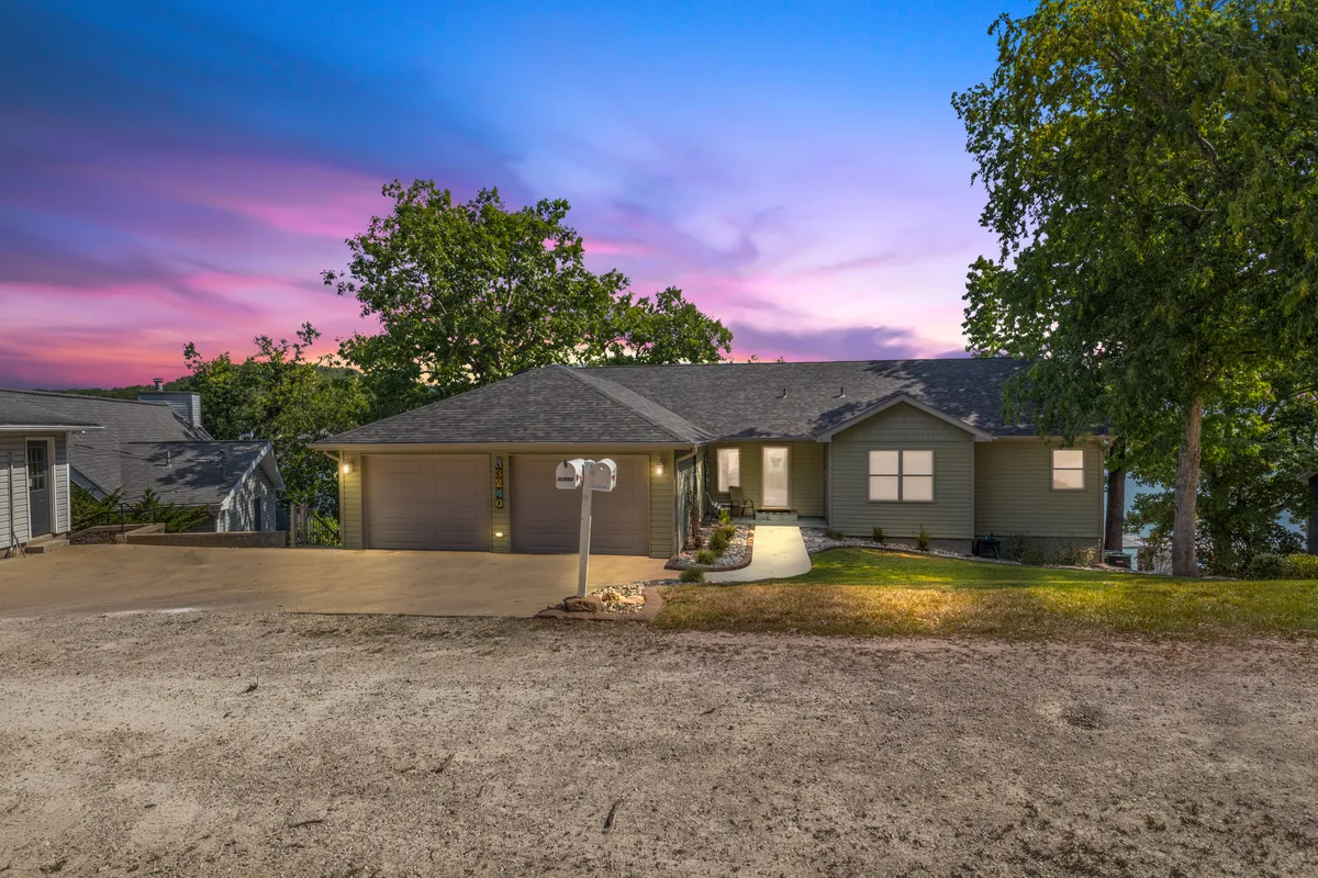 A view of the house’s facade including the driveway, mailbox, and landscaped yard, evoking a relaxed, home-like environment. The porch hints at spaces for gatherings or quiet moments outdoors, capturing the comfort aspect of the stay.