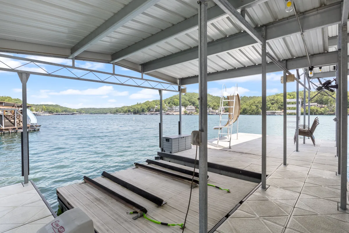 A quiet dock juts out into calm lake waters, complete with a lounge chair that invites mornings spent with coffee or evenings watching the sunset. The wide, open sky makes this an ideal spot for spotting eagles, herons, and other local wildlife.